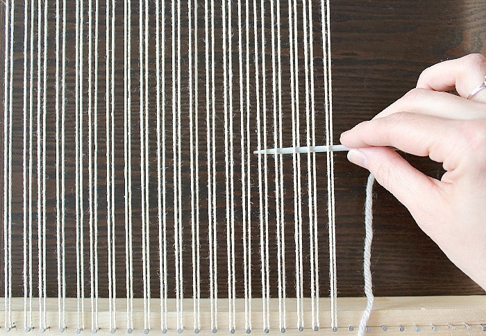 DIY Woven No-Sew Pillow - begin first row of weaving.