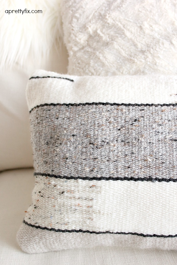 No sewing machine? No problem. Create this DIY Woven No-Sew Pillow with a basic loom, yarn, and pillow stuffing. A simple way to add a homemade touch to your home.