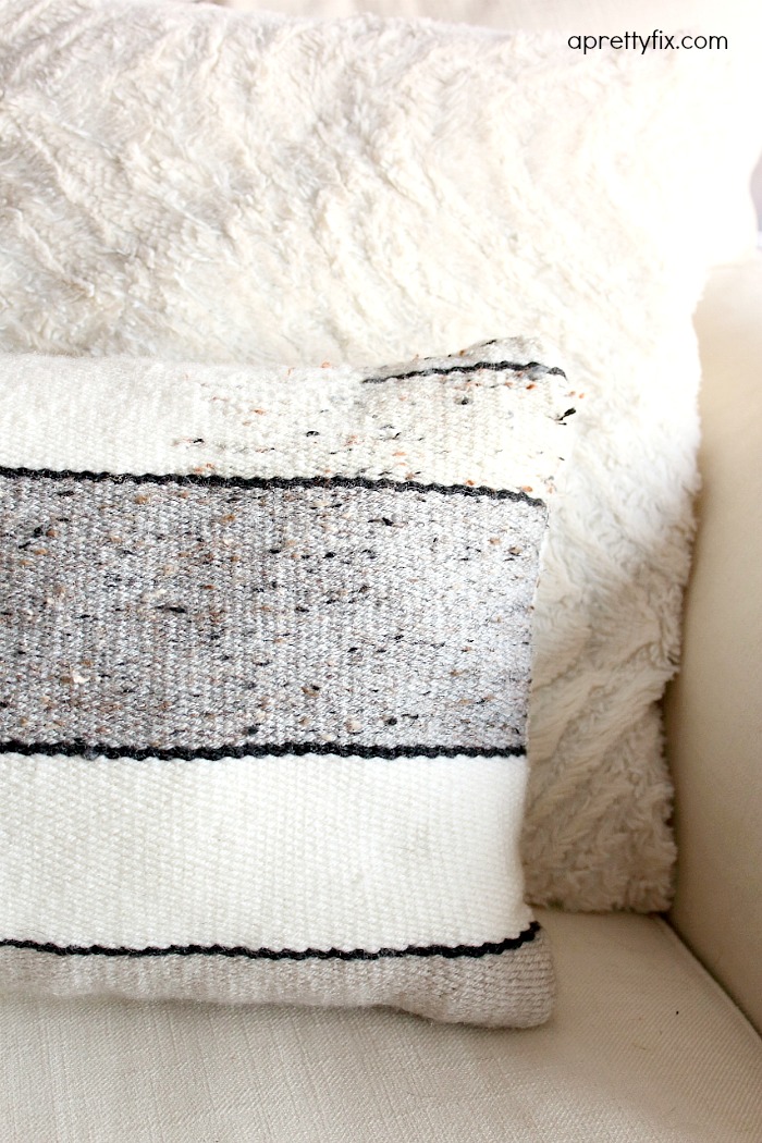 No sewing machine? No problem. Create this DIY Woven No-Sew Pillow with a basic loom, yarn, and pillow stuffing. A simple way to add a homemade touch to your home.