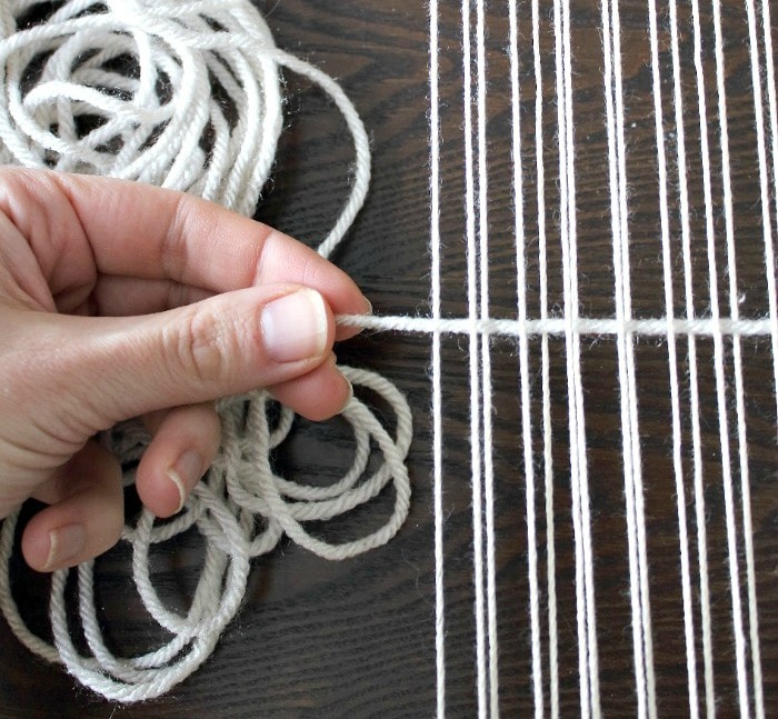 DIY Woven No-Sew Pillow - pull first row of yarn through.